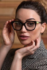 Young girl in glasses and a jacket. Close-up portrait.