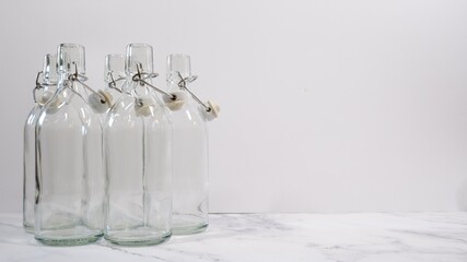 5 empty swing-top bottles are ready to be filled with homemade juice, kombucha, beer or other liquid