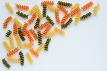 Tricolore fusilli italian pasta on white background.