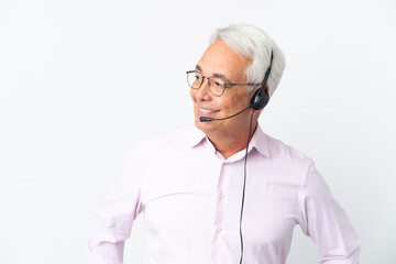 Telemarketer Middle age man working with a headset isolated on white background looking to the side...
