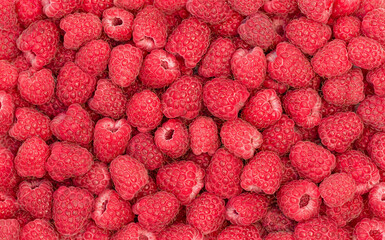 Summer background of red ripe raspberry - top view