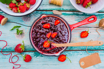 Homemade jam with fresh strawberries.