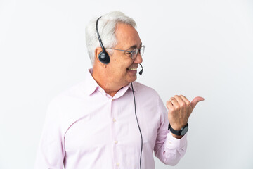 Telemarketer Middle age man working with a headset isolated on white background pointing to the side to present a product