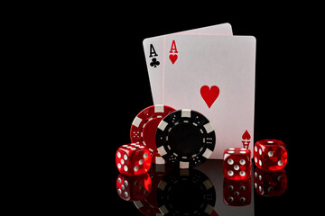 Obraz premium Casino chips, playing cards and dices on dark reflective background
