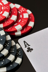 Casino chips and playing cards on dark reflective background