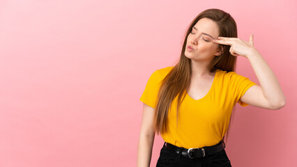 Teenager girl over isolated pink background with problems making suicide gesture