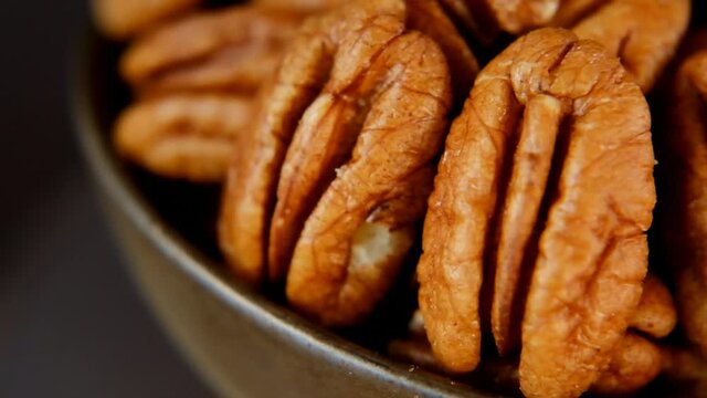 Pecan nut close-up in a brown cup.Rotation.Organic Fresh Pecans.slow motion