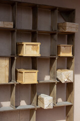 Open wooden shelves on which the indicated parcels lie in wooden boxes. Free space in empty cells.