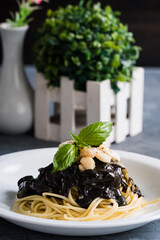 bay scallop and squid in black ink pasta sauce