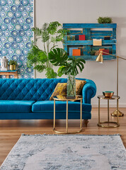Blue classic sofa furniture home design, gold lamp and middle table, wooden palette bookshelf, vase of green plant and home accessory style,interior decor.