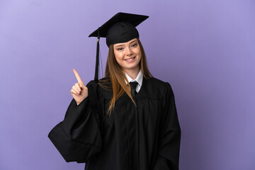 Young university graduate over isolated purple background showing and lifting a finger in sign of the best