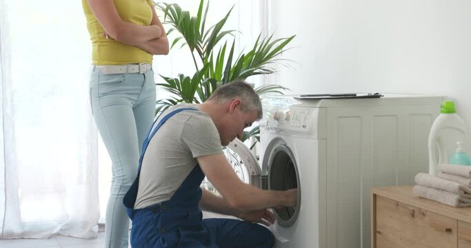 Technician checking a broken washing machine