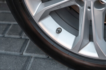 Closeup of car wheel nipple. A fragment of the wheel of the car with the nipple. A part of an...