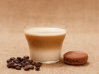 Coffee cappuccino and coffee beans on sackcloth background