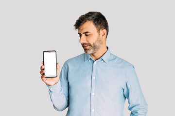 Man holding and looking at smart phone with mockup on white background