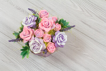 Handmade flowers as a gift on the gray background