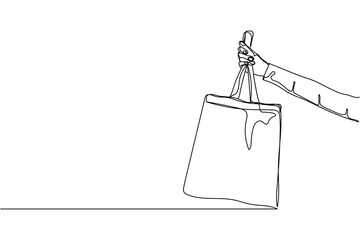 Continuous one line of hand holding eco bag in silhouette on a white background. Linear stylized.Minimalist.