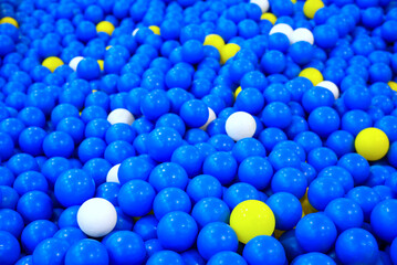 Lots of blue, yellow plastic balls. in the public playground Use as a background to look beautiful.