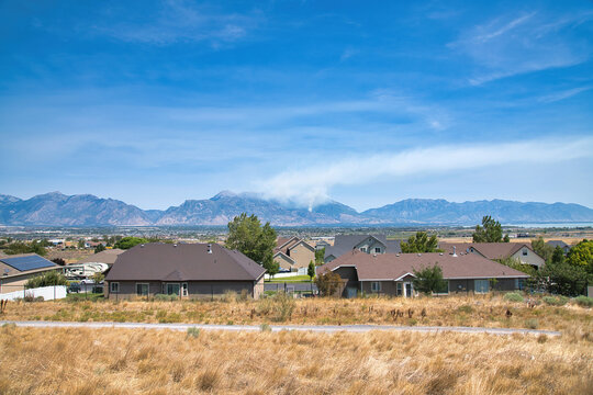 Residential houses in Utah Valley with view of wildfire in the Wasatch Mountains