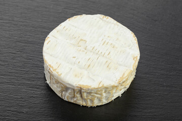 Cheese  Camembert on a black board for serving food.