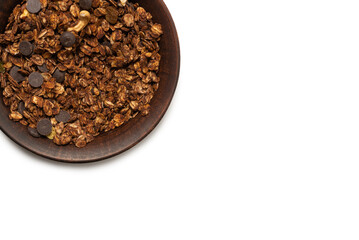 Chocolate granola cereal with nuts in a bowl background.