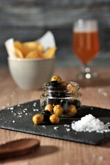 jar of black and green olives, lined with aromatic herbs appetizers, snacks and pickles