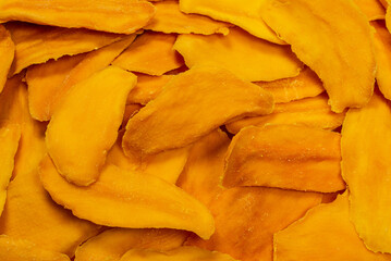 Dry sugar mango slices as a background.