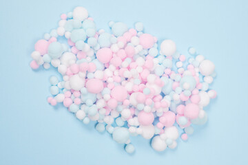 White, pink and blue soft pompons as a background.