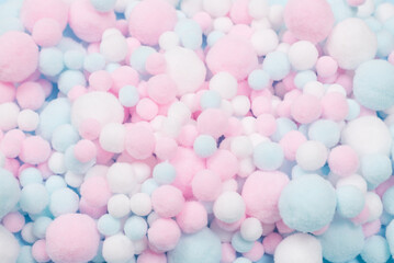 White, pink and blue soft pompons as a background.