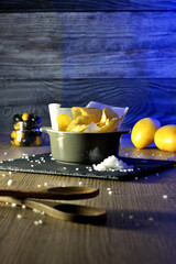 still life bowl of potato chips. Appetizers and snacks. culinary photography rustic and dark