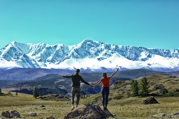 Fototapeta na wymiar couple hands up mountains, landscape adventure active view