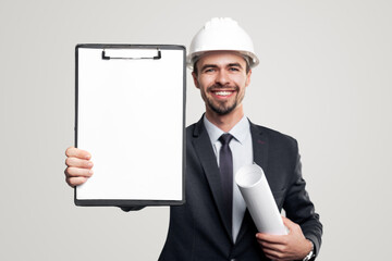 Cheerful engineer showing blank clipboard