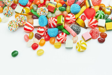 Multi-colored gummy candies on a white background. Festive backdrop.