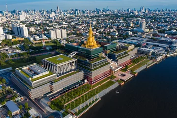 Selbstklebende Fototapeten Aerial view of Bangkok skyline and skyscraper with new Thai parliament, Sappaya Sapasathan (The Parliament of Thailand).National Assembly with a golden pagoda on the Chao Phraya River in Bangkok. 4k  © AU USAnakul+