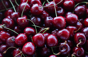 a large number of red cherries filling the entire frame 