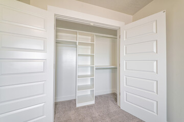 Wardrobe cabinet with empty clothes rod and shelves inside a residential home