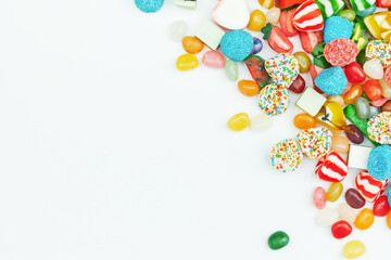 Multi-colored gummy candies on a white background. Festive frame backdrop.