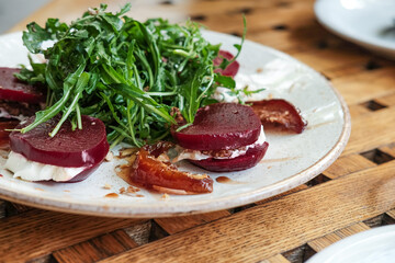 Close up sliced beetroot salad plate. Arugula and beet root salad. 