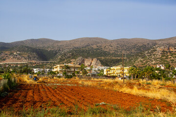 Fototapeta na wymiar Red soil in a plowed field on the island of Crete, Greece.