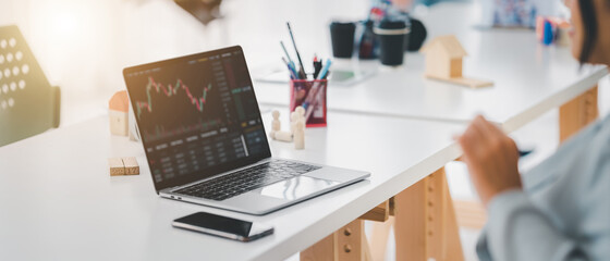 Young money businessman sitting staring at a computer screen displaying a cryptocurrency featuring stock tickers or graphs. Stock trading platform concept. professional financial advisor.