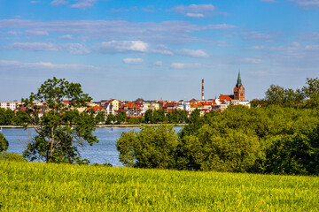 Panorama of Elk historic city center with Holiest Heart of Jesus neo-gothic church tower on shore of Jezioro Elckie lake in Masuria region of Poland
