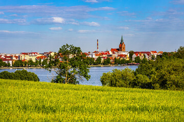 Panorama of Elk historic city center with Holiest Heart of Jesus neo-gothic church tower on shore of Jezioro Elckie lake in Masuria region of Poland