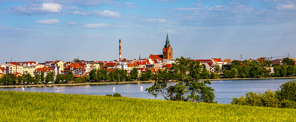 Panorama of Elk historic city center with Holiest Heart of Jesus neo-gothic church tower on shore...