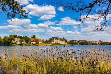 Panorama of Elk historic city center with Holiest Heart of Jesus church tower and Elk castle on shore of Jezioro Elckie lake in Masuria region of Poland