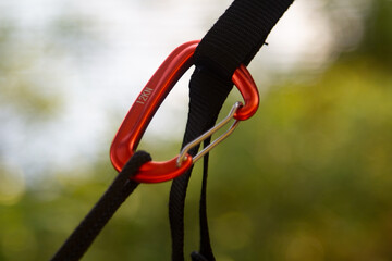 Installation of a hammock on slings and a carabin. Macro photo. Camping concept.