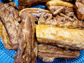 Slow Cooker Pork Belly (Samgyupsal), Boiled pork belly in red basket, Prepared food concept.
