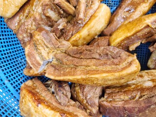 Slow Cooker Pork Belly (Samgyupsal), Boiled pork belly in red basket, Prepared food concept.