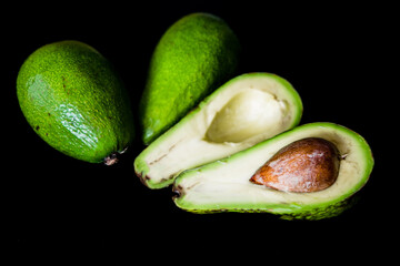 Avocado cut on a black background