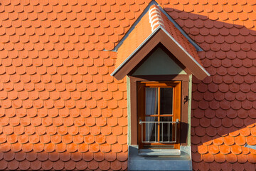 Tile roof with a window on sunny day