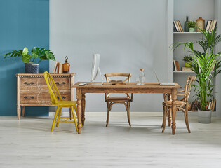 Decorative wooden furniture office room with computer and laptop style, retro cabinet and shelf background, blue and grey wall interior concept.